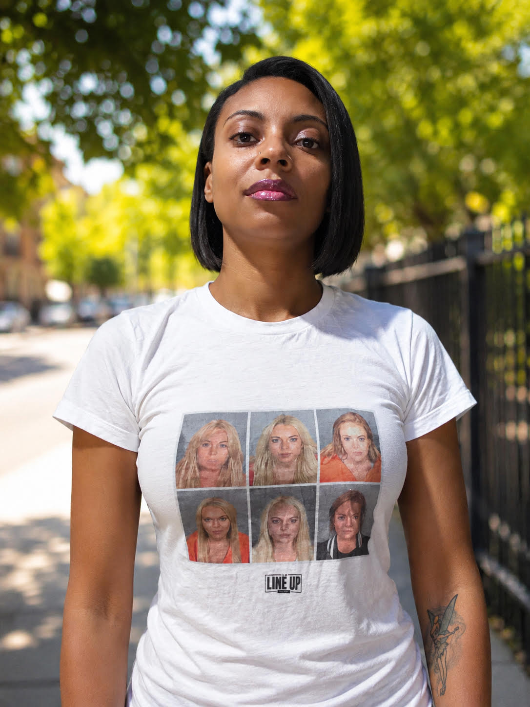 Person wearing a white t-shirt with six Lindsay Lohan mugshots on it by The Line Up Dept.